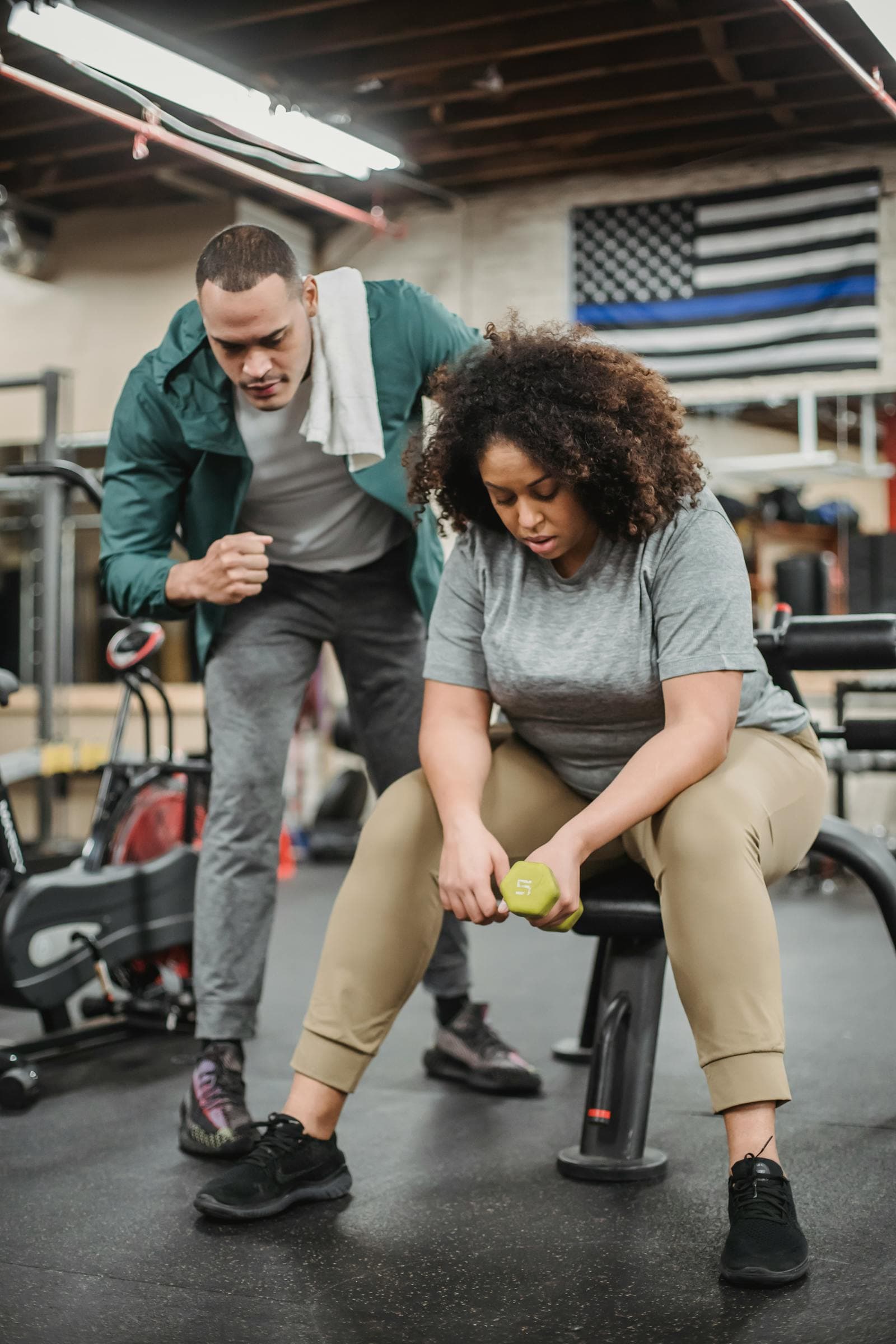 Fitness coach helping a client during a training session